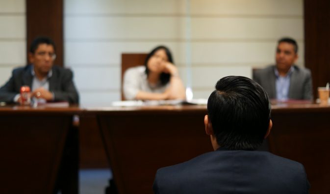 man in black shirt sitting beside woman in white shirt
